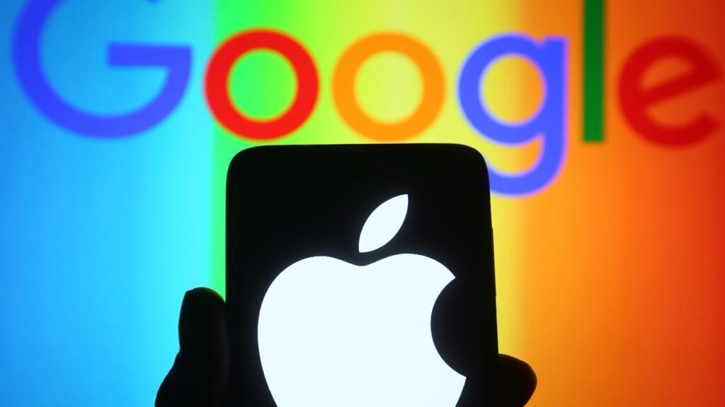 Apple logo on phone with Google logo in the background